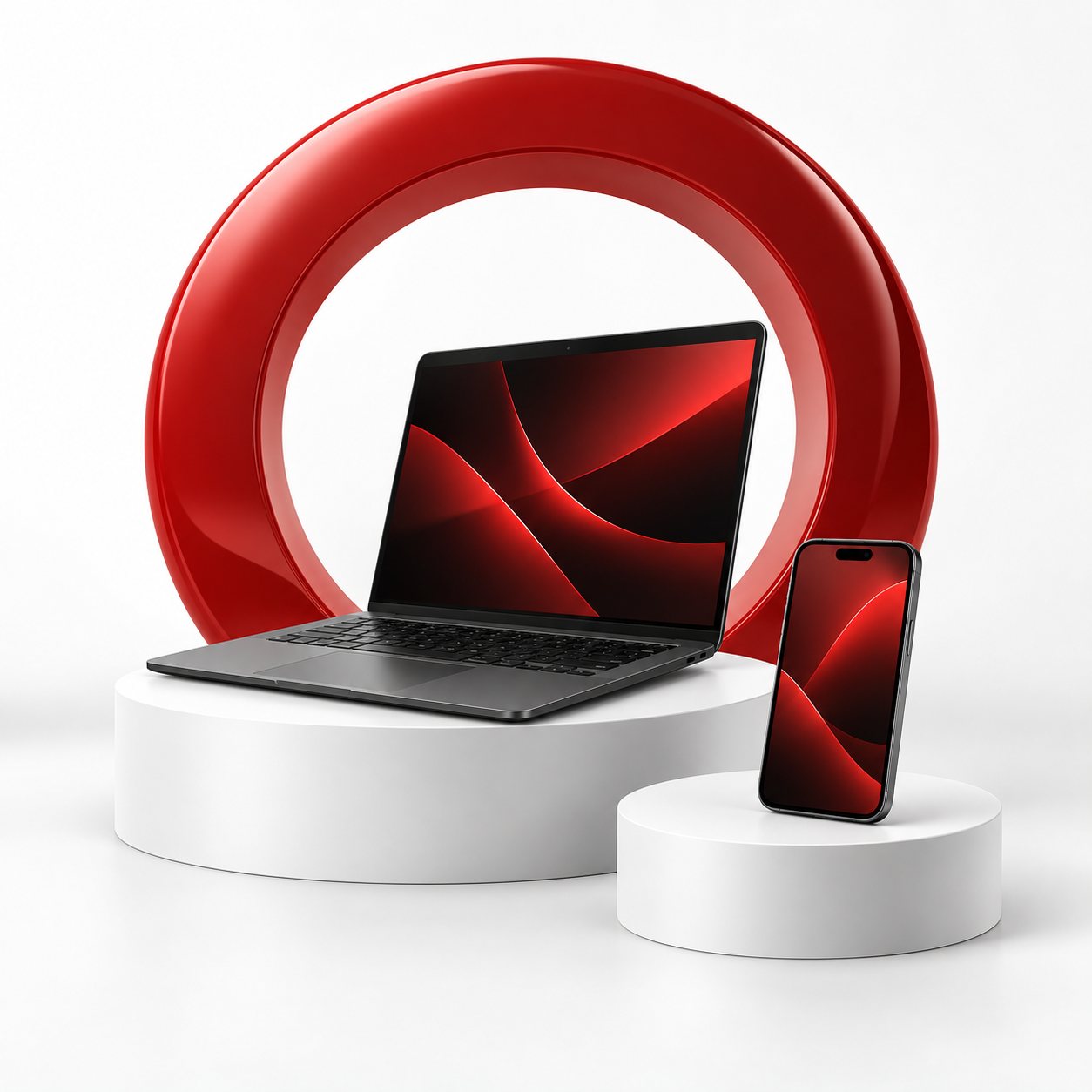 Laptop and phone beside a red connected ring