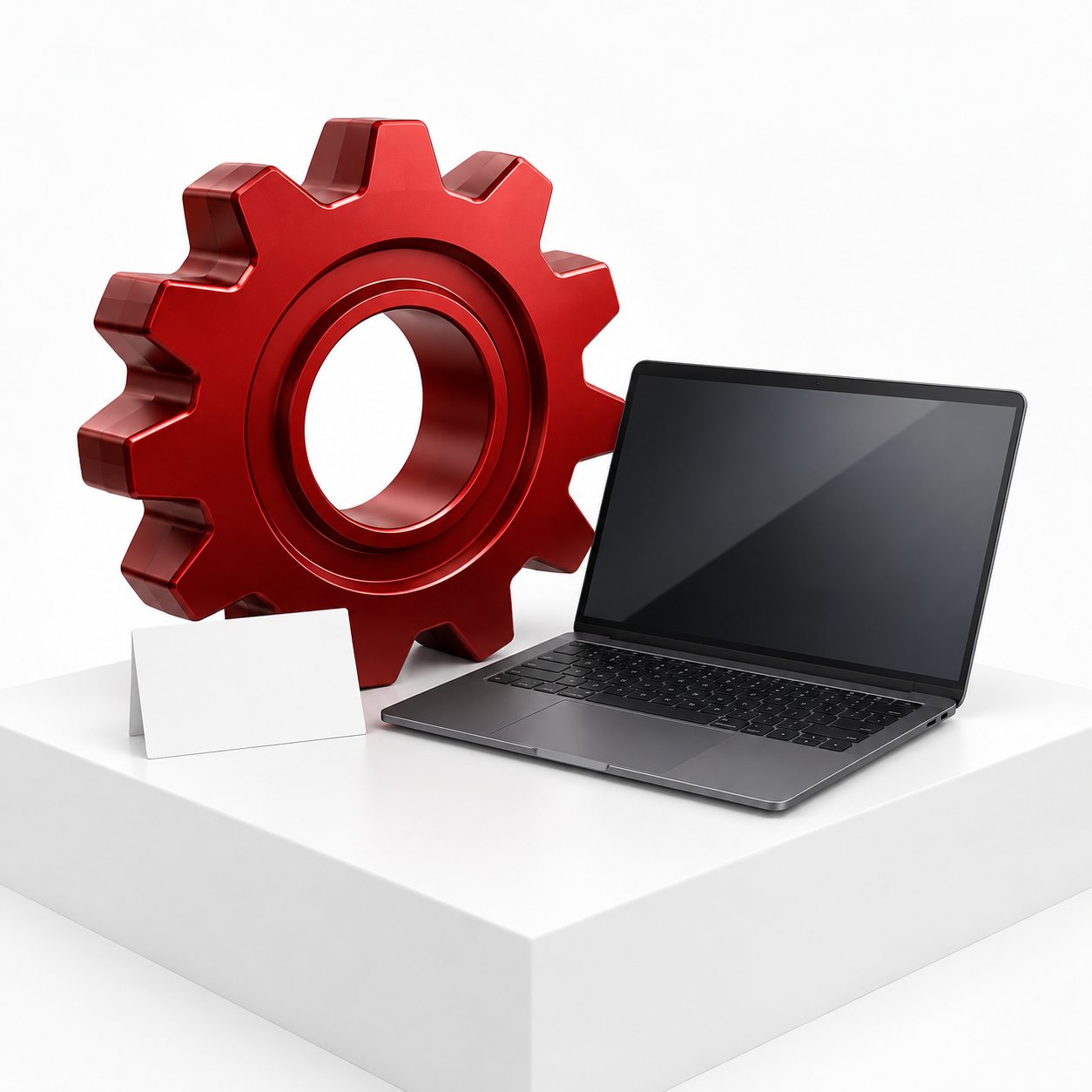 Red gear beside a graphite laptop and a blank setup card